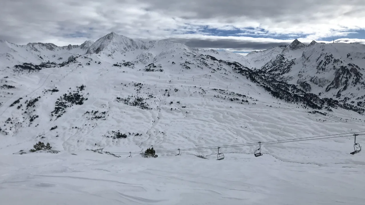 A rider on the open, snowy freeride terrain at Baqueira Beret in the Val d'Aran