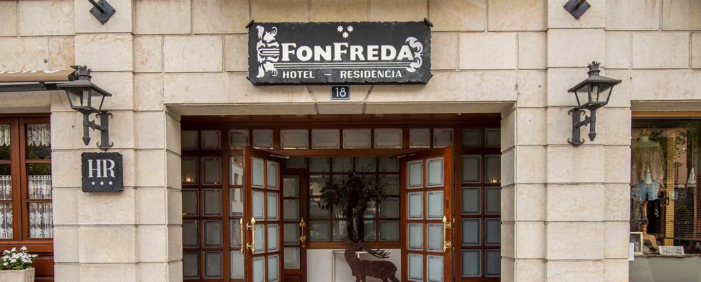The stone entrance and Fonfreda sign of Hotel Fonfreda in central Vielha