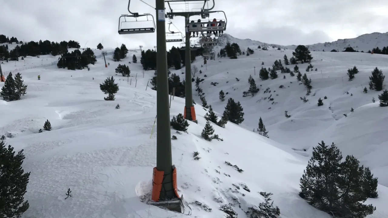 Pistes and chairlifts across the Baqueira Beret ski area beneath the Pyrenees peaks