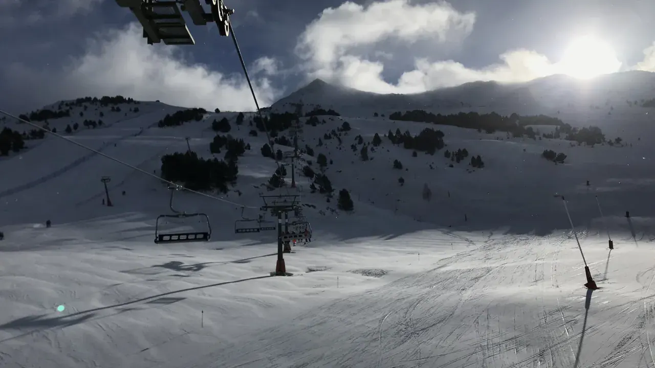 A chairlift above the pistes at Baqueira Beret on a bright winter day