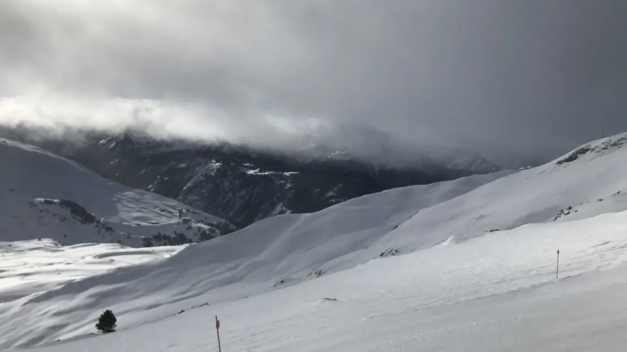 Untracked snowfields and low cloud over the mountains at Baqueira Beret
